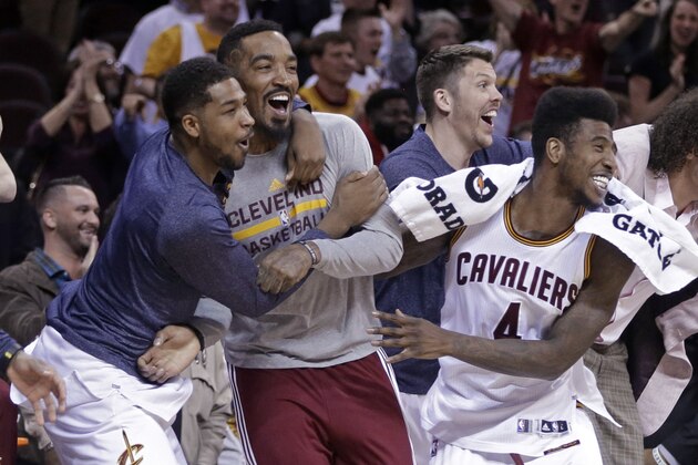 Cleveland Cavaliers' Tristan Thompson, left, J.R. Smith, second form left, Mike Miller, third from left, Iman Shumpert (4) and Anderson Varejao, right, celebrate after a 113-108 win in overtime over the Washington Wizards in an NBA basketball game Wednesday, April 15, 2015, in Cleveland. (AP Photo/Mark Duncan)