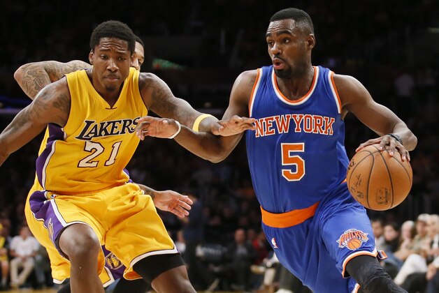 New York Knicks' Tim Hardaway Jr., right, drives past Los Angeles Lakers' Ed Davis during the second half of an NBA basketball game, Thursday, March 12, 2015, in Los Angeles. The Knicks won 101-94. (AP Photo/Danny Moloshok)