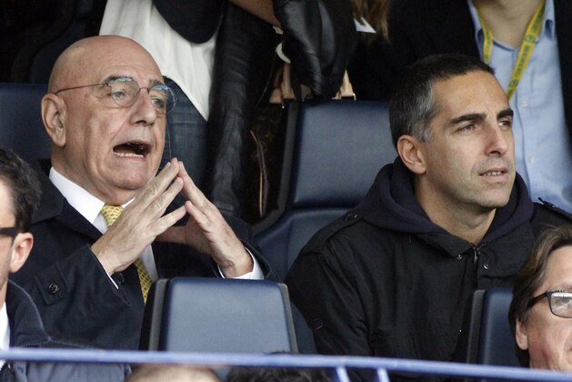 AC Milan vice president Adriano Galliani, left, and his son Gianluca follow a Serie A soccer match between Chievo and AC Milan at Bentegodi stadium in Verona, Italy, Sunday, Nov. 10, 2013. (AP Photo/Felice Calabro')