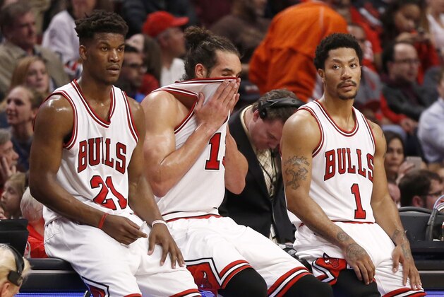 Chicago Bulls' players from left, Jimmy Butler, Joakim Noah, and Derrick Rose, wait for play to resume during the second half in Game 5 of the NBA basketball playoffs against the Milwaukee Bucks Monday, April 27, 2015, in Chicago. The Bucks won 94-88. (AP Photo/Charles Rex Arbogast)