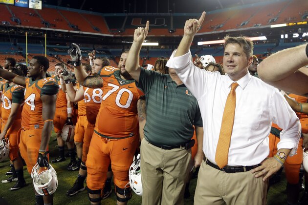 Miami head coach Al Golden, right, sings the alma mater with the team after Miami defeated Florida A&M 41-7 in an NCAA football game, Saturday, Sept. 6, 2014, in Miami Gardens, Fla. (AP Photo/Lynne Sladky)