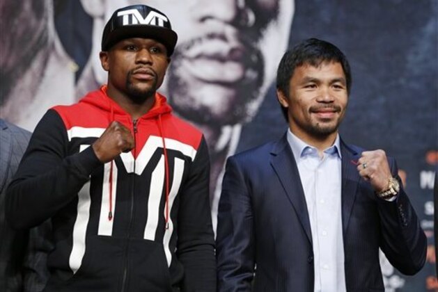 Boxers Floyd Mayweather Jr., left, and Manny Pacquiao pose for photographers during a press conference Wednesday, April 29, 2015, in Las Vegas. The pair are slated to square off Saturday in Las Vegas. (AP Photo/John Locher)