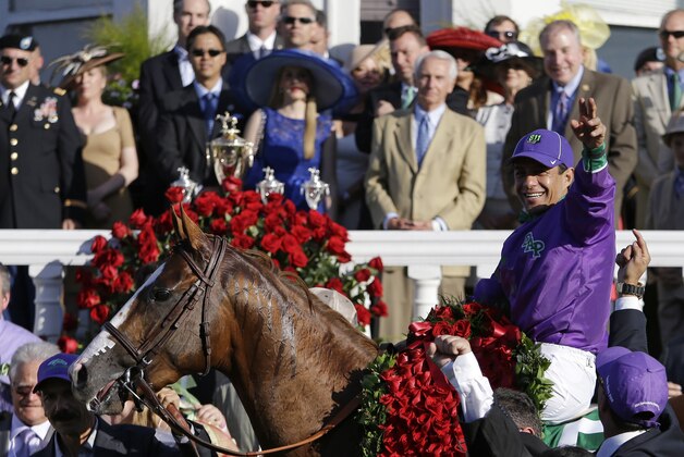 Victor Espinoza celebrates after riding California Chrome to victory in the 140th running of the Kentucky Derby horse race at Churchill Downs Saturday, May 3, 2014, in Louisville, Ky. (AP Photo/David Goldman)