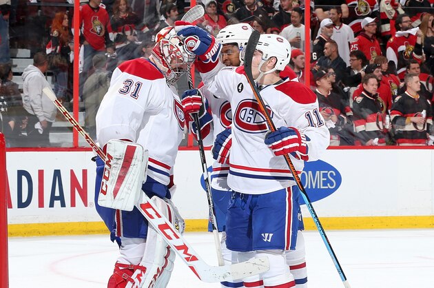 OTTAWA, ON - APRIL 26: Carey Price #31,Devante Smith-Pelly #21 and Brendan Gallagher #11 of the Montreal Canadiens celebrate their game win against the Ottawa Senators to win their series  in Game Six of the Eastern Conference Quarterfinals during the 2015 NHL Stanley Cup Playoffs at Canadian Tire Centre on April 26, 2015 in Ottawa, Ontario, Canada.  (Photo by Jana Chytilova/NHLI via Getty Images)