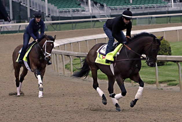 Kentucky Derby entrants Firing Line, right, ridden by Humberto Gomez, gallops followed by Tencendur, ridden by Blair Golen, at Churchill Downs in Louisville, Ky., Thursday, April 30, 2015.  (AP Photo/Garry Jones)