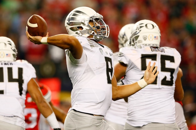 ARLINGTON, TX - JANUARY 12:  Quarterback Marcus Mariota #8 of the Oregon Ducks throws the ball against the Ohio State Buckeyes during the College Football Playoff National Championship Game at AT&T Stadium on January 12, 2015 in Arlington, Texas.  (Photo by Kevin C. Cox/Getty Images)