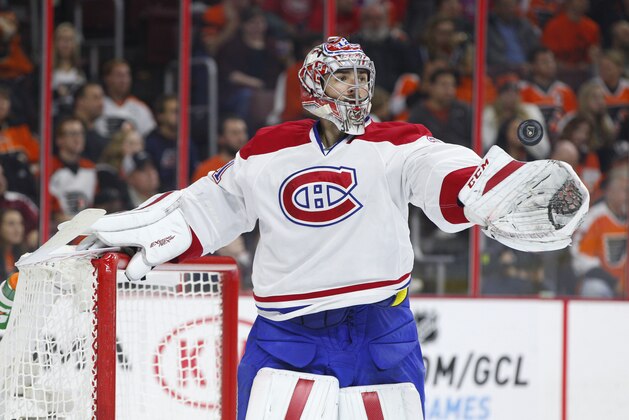 Montreal Canadiens' Carey Price tosses the puck during the second period of an NHL hockey game against the Philadelphia Flyers, Saturday, Oct. 11, 2014, in Philadelphia. (AP Photo/Chris Szagola)