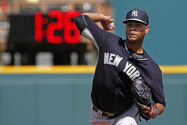 New York Yankees pitcher Esmil Rogers (53) warms up between innings of a spring training exhibition baseball game against the Pittsburgh Pirates in Bradenton, Fla., Thursday, March 5, 2015. The clock in the outfield counts down from three minutes between innings. (AP Photo/Gene J. Puskar)