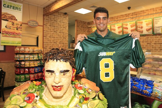 IMAGE DISTRIBUTED FOR SUBWAY - Marcus Mariota, 2015 draft prospect and newest SUBWAY Famous Fan, poses with a life-size food statue made of SUBWAY sandwich ingredients in his likeness, including new SUBWAY guacamole, and a custom jersey with his signature number 8, on Wednesday, April 22, 2015, in Honolulu. Mariota joins a roster of SUBWAY Famous Fans including Clayton Kershaw, Mike Trout, Russell Westbrook, Robert Griffin III, Justin Tuck, Nastia Liukin and Pelé. (Photo by Marco Garcia /Invision for SUBWAY/AP Images)