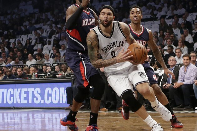Brooklyn Nets guard Deron Williams (8) drives around Atlanta Hawks forward DeMarre Carroll (5) in the first quarter of Game 4 of a first round NBA playoff basketball game, Monday, April 27, 2015, in New York. (AP Photo/Kathy Willens)