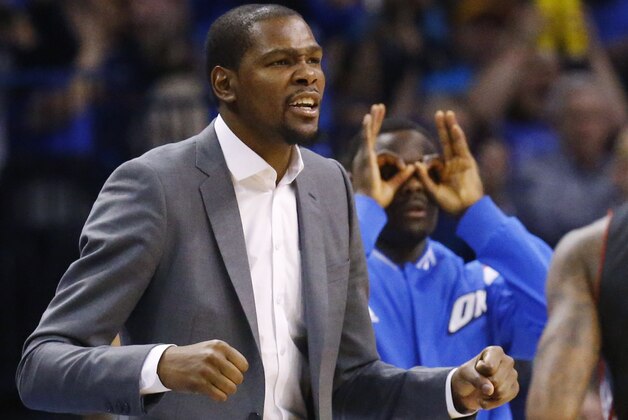 Injured Oklahoma City Thunder forward Kevin Durant reacts on the bench to a basket in the fourth quarter of an NBA basketball game against the Toronto Raptors in Oklahoma City, Sunday, March 8, 2015. Oklahoma City won 108-104. (AP Photo/Sue Ogrocki)