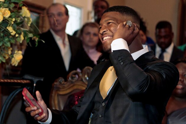 Jameis Winston takes the call from the Tampa Bay Buccaneers, Thursday, April 30, 2015, in Bessemer, Ala. The Tampa Bay Buccaneers get to stress out for the next three or four years to see what really comes of the first pick of the NFL draft _ quarterback Jameis Winston of Florida State. (AP Photo/Butch Dill)