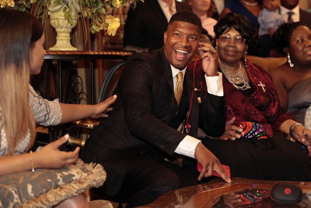 Jameis Winston takes the call from the Tampa Bay Buccaneers to be selected as the number one draft pick, Thursday, April 30, 2015, in Bessemer, Ala. (AP Photo/Butch Dill)