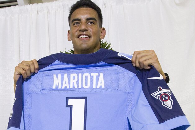 Former Oregon quarterback Marcus Mariota holds up his Tennessee Titians jersey for the media after being selected in the first round with the second pick by the Tennessee Titans on NFL Draft Day Thursday, April 30, 2015, in Honolulu. Mariota along with his family and friends gathered at the Saint Louis Alumni Clubhouse to celebrate his selection in the NFL Draft. (AP Photo/Eugene Tanner) Former Oregon quarterback Marcus Mariota holds up his Tennessee Titians jersey for the media after being selected in the first round with the second pick by the Tennessee Titans on NFL Draft Day Thursday, April 30, 2015, in Honolulu. Mariota along with his family and friends gathered at the Saint Louis Alumni Clubhouse to celebrate his selection in the NFL Draft. (AP Photo/Eugene Tanner)