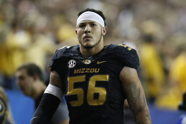 Missouri defensive lineman Shane Ray (56) walks off the field after being ejected from the game for a late hit against Alabama quarterback Blake Sims during the first half of the Southeastern Conference championship NCAA college football game, Saturday, Dec. 6, 2014, in Atlanta. (AP Photo/Brynn Anderson)