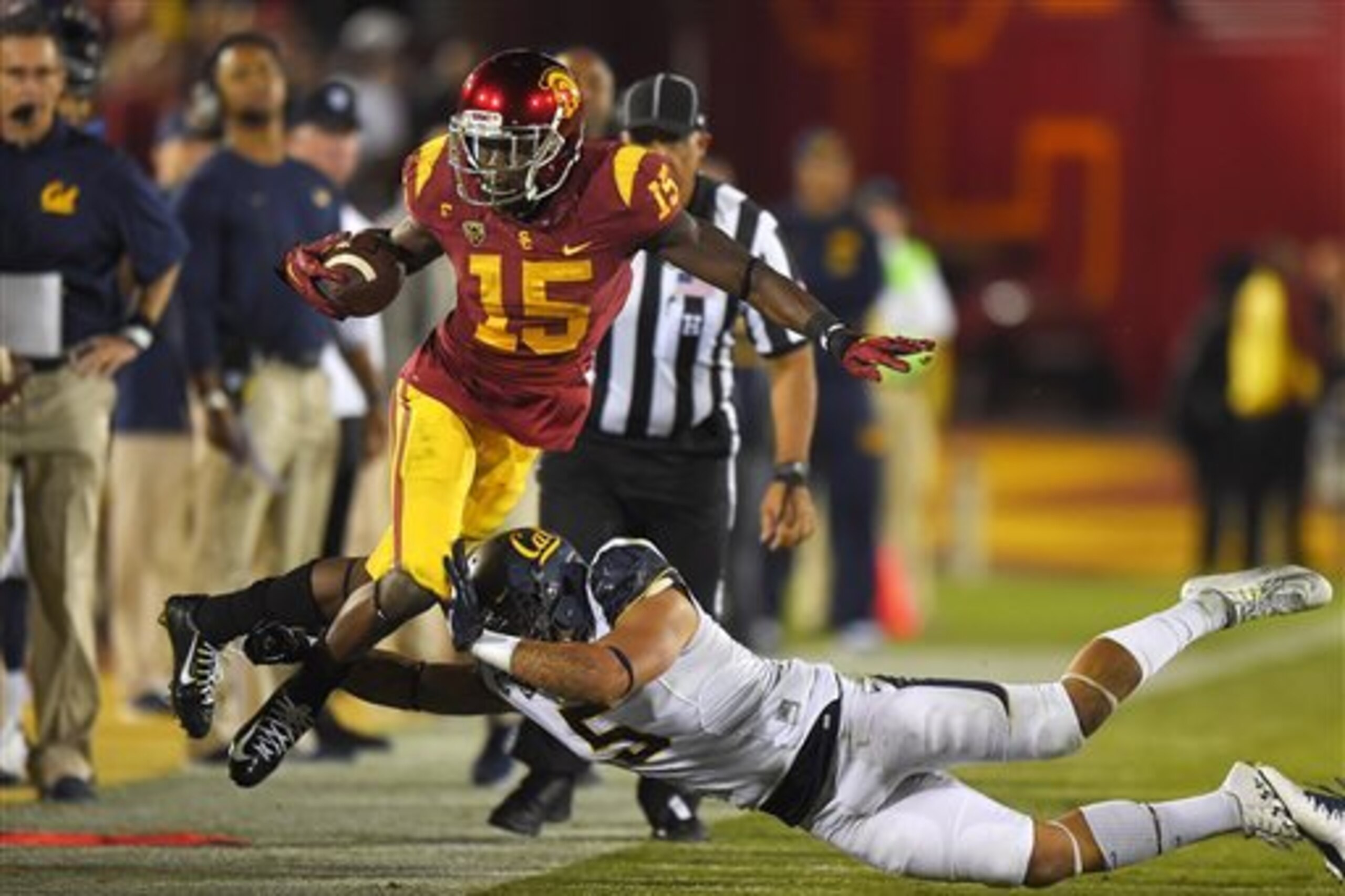 Southern California wide receiver Nelson Agholor, left, is knocked out of bounds by California safety Michael Lowe during the first half of an NCAA college football game, Thursday, Nov. 13, 2014, in Los Angeles. (AP Photo/Mark J. Terrill)