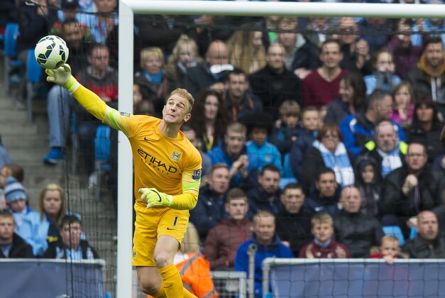 Aston Villa's Christian Benteke, right, after a missed opportunity to score past Joe Hart, left, during the English Premier League soccer match between Manchester City and Aston Villa at the Etihad Stadium, Manchester, England, Saturday April 25, 2015. (AP Photo/Jon Super)