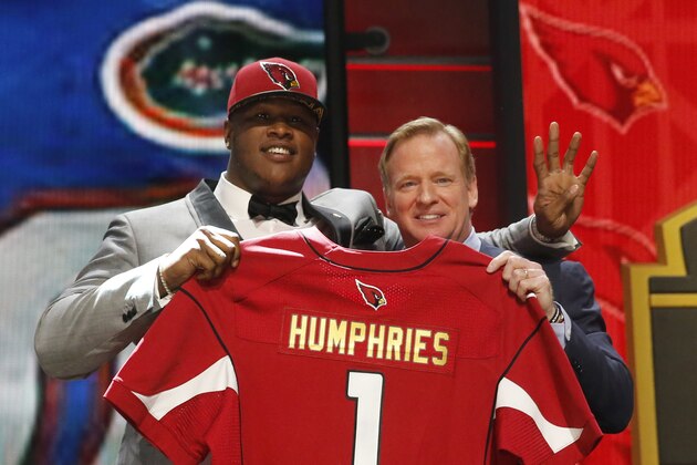 Florida offensive lineman D.J. Humphries poses for photos with NFL commissioner Roger Goodell after being selected by the Arizona Cardinals as the 24th pick in the first round of the 2015 NFL Draft,  Thursday, April 30, 2015, in Chicago. (AP Photo/Charles Rex Arbogast)