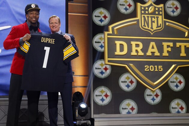 Kentucky linebacker Bud Dupree poses for photos with NFL commissioner Roger Goodell after being selected by the Pittsburgh Steelers as the 22nd pick in the first round of the 2015 NFL Draft,  Thursday, April 30, 2015, in Chicago. (AP Photo/Charles Rex Arbogast)
