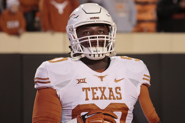 STILLWATER, OK - NOVEMBER 15:   Defensive tackle Malcom Brown #90 of the Texas Longhorns looks at the video board before the game against the Oklahoma State Cowboys November 15, 2014 at Boone Pickens Stadium in Stillwater, Oklahoma. The Longhorns defeated the Cowboys 28-7.  (Photo by Brett Deering/Getty Images)