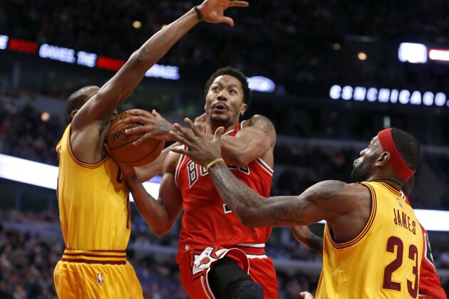 Chicago Bulls guard Derrick Rose (1) drives and scores past Cleveland Cavaliers' James Jones, left, and LeBron James during the second half of an NBA basketball game Thursday, Feb. 12, 2015, in Chicago. The Bulls won 113-98. (AP Photo/Charles Rex Arbogast)