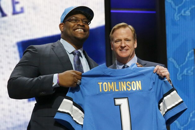 Duke offensive lineman Laken Tomlinson poses for photos with NFL commissioner Roger Goodell after being selected by the Detroit Lions as the 28th pick in the first round of the 2015 NFL Draft,  Thursday, April 30, 2015, in Chicago. (AP Photo/Charles Rex Arbogast)