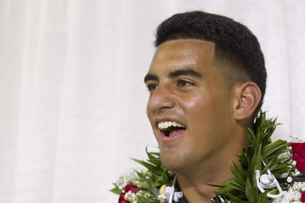 Former Oregon quarterback Marcus Mariota laughs while fielding questions from the media after being selected in the first round with the second pick by the Tennessee Titans on NFL Draft Day Thursday, April 30, 2015, in Honolulu. Mariota along with his family and friends gathered at the Saint Louis Alumni Clubhouse to celebrate his selection in the NFL Draft. (AP Photo/Eugene Tanner)
