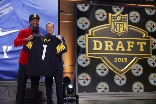 Kentucky linebacker Bud Dupree poses for photos with NFL commissioner Roger Goodell after being selected by the Pittsburgh Steelers as the 22nd pick in the first round of the 2015 NFL Draft,  Thursday, April 30, 2015, in Chicago. (AP Photo/Charles Rex Arbogast)