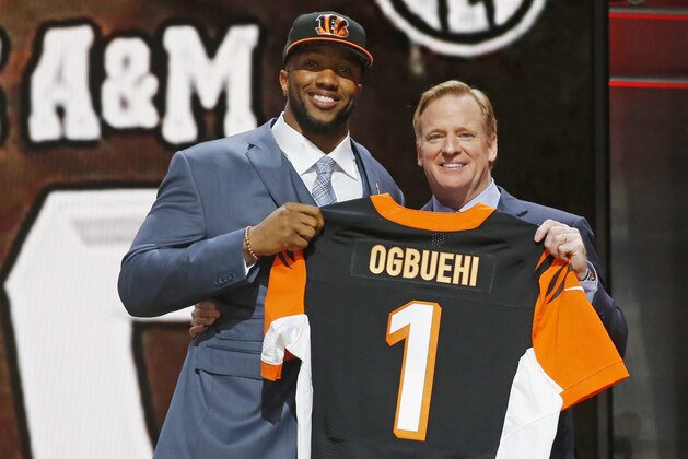 Texas A&M offensive lineman Cedric Ogbuehi poses for photos with NFL commissioner Roger Goodell after being selected by the Cincinnati Bengals as the 21st pick in the first round of the 2015 NFL Draft,  Thursday, April 30, 2015, in Chicago. (AP Photo/Charles Rex Arbogast)