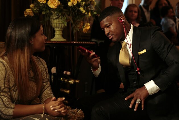Breion Allen watches as Jameis Winston takes the call from the Tampa Bay Buccaneers to be selected as the number one draft pick, Thursday, April 30, 2015, in Bessemer, Ala. (AP Photo/Butch Dill)
