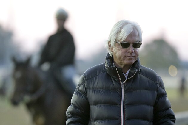 FILE - In this April 28, 2015 file photo, trainer Bob Baffert watches horses workout at Churchill Downs, in Louisville, Ky. Before Baffert won the Kentucky Derby for the first time, he lost.  Seize the moment is Baffert's mantra. Don't think about those glorious wins by Silver Charm in '97, Real Quiet in '98 and War Emblem in '02. And for sure, don't even mention the losses. Three of them with favorites, one by a nose, and another with the horse he calls the best he's ever trained. Of course, that tune could change by Saturday night. (AP Photo/Charlie Riedel, File)