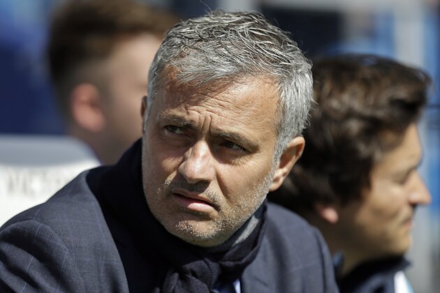 Chelsea's Chelsea manager Jose Mourinho takes his seat on the bench before the English Premier League soccer match between QPR and Chelsea at Loftus Road stadium in London, Sunday, April 12, 2015. (AP Photo/Matt Dunham)