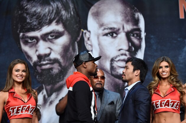 LAS VEGAS, NV - APRIL 29:  WBC/WBA welterweight champion Floyd Mayweather Jr. (L) and WBO welterweight champion Manny Pacquiao face off during a news conference at the KA Theatre at MGM Grand Hotel & Casino on April 29, 2015 in Las Vegas, Nevada. The two will face each other in a unification bout on May 2, 2015 in Las Vegas.  (Photo by Ethan Miller/Getty Images)