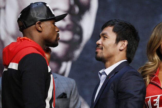 Floyd Mayweather Jr., left, and Manny Pacquiao pose for photographers during a news conference Wednesday, April 29, 2015, in Las Vegas. Mayweather will face Pacquiao in a welterweight boxing match in Las Vegas on May 2. (AP Photo/John Locher)