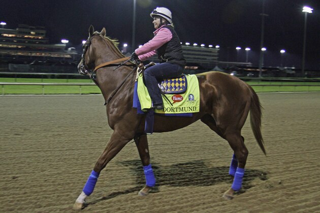 Kentucky Derby entrant Dortmund, with exercise rider Dana Barnes aboard, goes to the track for his morning gallop at Churchill Downs in Louisville, Ky., Friday, May 1, 2015.  (AP Photo/Garry Jones)