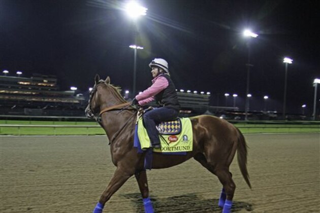 Kentucky Derby entrant Dortmund, with exercise rider Dana Barnes aboard, goes to the track for his morning gallop at Churchill Downs in Louisville, Ky., Friday, May 1, 2015.  (AP Photo/Garry Jones)