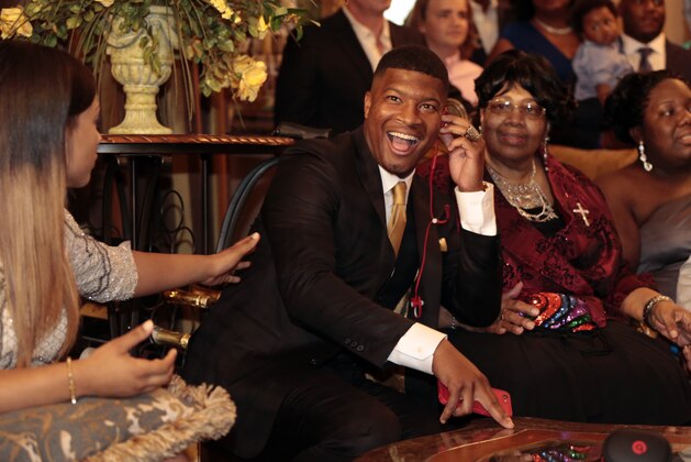 Jameis Winston takes the call from the Tampa Bay Buccaneers to be selected as the number one draft pick, Thursday, April 30, 2015, in Bessemer, Ala. (AP Photo/Butch Dill)