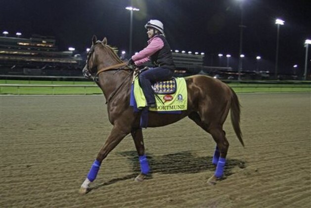 Kentucky Derby entrant Dortmund, with exercise rider Dana Barnes aboard, goes to the track for his morning gallop at Churchill Downs in Louisville, Ky., Friday, May 1, 2015.  (AP Photo/Garry Jones)