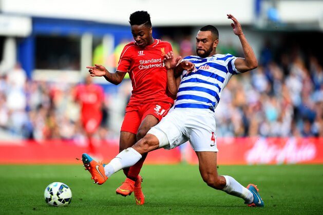 LONDON, ENGLAND - OCTOBER 19:  Steven Caulker of QPR battles for the ball with Raheem Sterling of Liverpool during the Barclays Premier League match between Queens Park Rangers and Liverpool at Loftus Road on October 19, 2014 in London, England.  (Photo by Paul Gilham/Getty Images)