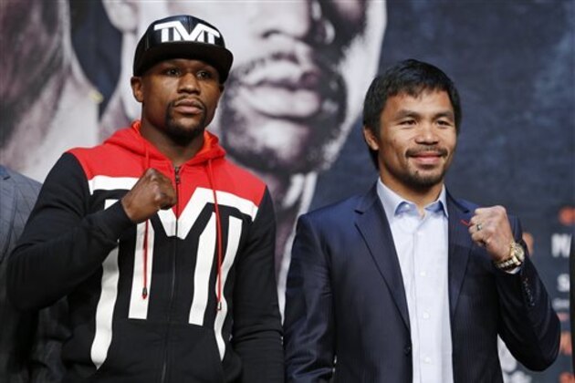 Boxers Floyd Mayweather Jr., left, and Manny Pacquiao pose for photographers during a press conference Wednesday, April 29, 2015, in Las Vegas. The pair are slated to square off Saturday in Las Vegas. (AP Photo/John Locher)