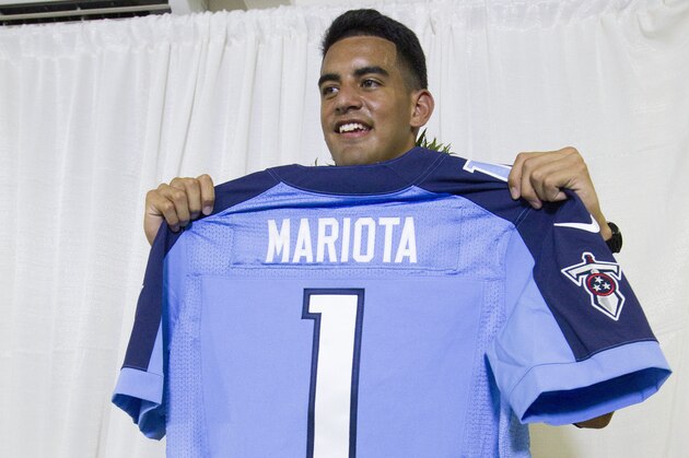 Former Oregon quarterback Marcus Mariota holds up his Tennessee Titans jersey after addressing the media during his press conference on NFL Draft Day Thursday, April 30, 2015, in Honolulu. Mariota was selected in the first round with the second pick by the Titans . (AP Photo/Eugene Tanner)