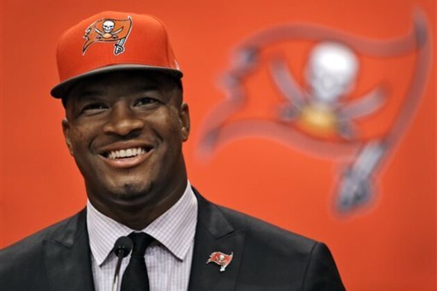 Former Florida State quarterback Jameis Winston, selected as the No.1 overall pick in the NFL draft by the Tampa Bay Buccaneers, smiles during a news conference Friday, May 1, 2015, in Tampa, Fla.  (AP Photo/Chris O'Meara)