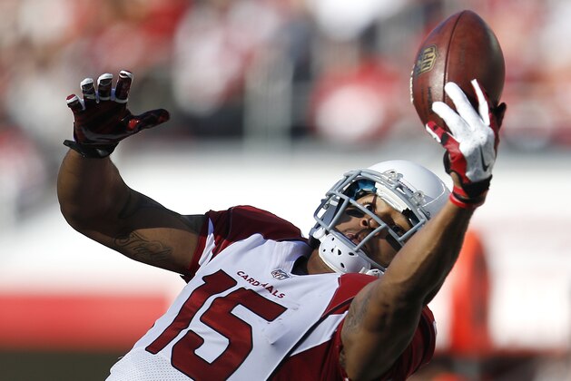 Arizona Cardinals wide receiver Michael Floyd (15) catches a pass against the San Francisco 49ers during the first half of an NFL football game in Santa Clara, Calif., Sunday, Dec. 28, 2014. (AP Photo/Tony Avelar)
