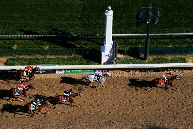 LOUISVILLE, KY - MAY 01:  Jockey Kerwin D. Clark celebrates atop of Lovely Maria #7 after crossing the finish line to win the 141st running of the Kentucky Oaks at Churchill Downs at Churchill Downs on May 1, 2015 in Louisville, Kentucky.  (Photo by Elsa/Getty Images)