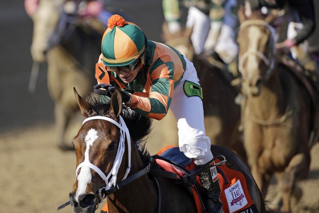 Kerwin D. Clark rides Lovely Maria to victory during the 141st running of the Kentucky Oaks horse race at Churchill Downs Friday, May 1, 2015, in Louisville, Ky. (AP Photo/David J. Phillip)