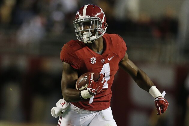 Alabama running back T.J. Yeldon (4) runs against Auburn  during the first half of the Iron Bowl NCAA college football game, Saturday, Nov. 29, 2014, in Tuscaloosa, Ala. (AP Photo/Butch Dill)