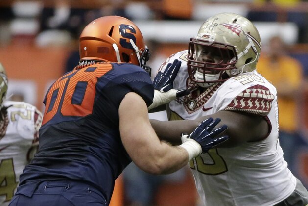 Florida State defensive tackle Eddie Goldman (90) attempts to beat Syracuse guard Nick Robinson (68) during the second half of an NCAA college football game Saturday, Oct. 11, 2014, in Syracuse, N.Y. Florida State won the game 38-20. (AP Photo/Frank Franklin II)