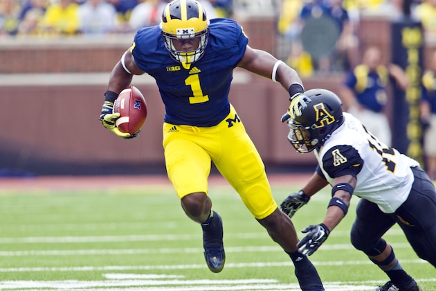 Michigan wide receiver Devin Funchess (1) breaks away from Appalachian State defensive back A.J. Howard, bottom, in the first quarter of  an NCAA college football game in Ann Arbor, Mich., Saturday, Aug. 30, 2014. (AP Photo/Tony Ding)