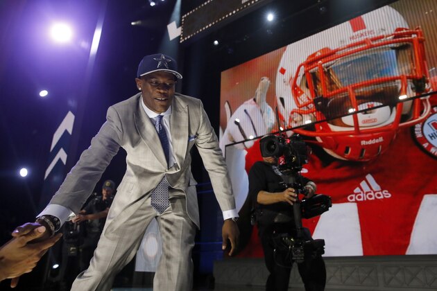 Nebraska defensive lineman Randy Gregory celebrates after being selected by the Dallas Cowboys as the 60th pick in the second round of the 2015 NFL Football Draft,  Friday, May 1, 2015, in Chicago. (AP Photo/Charles Rex Arbogast)