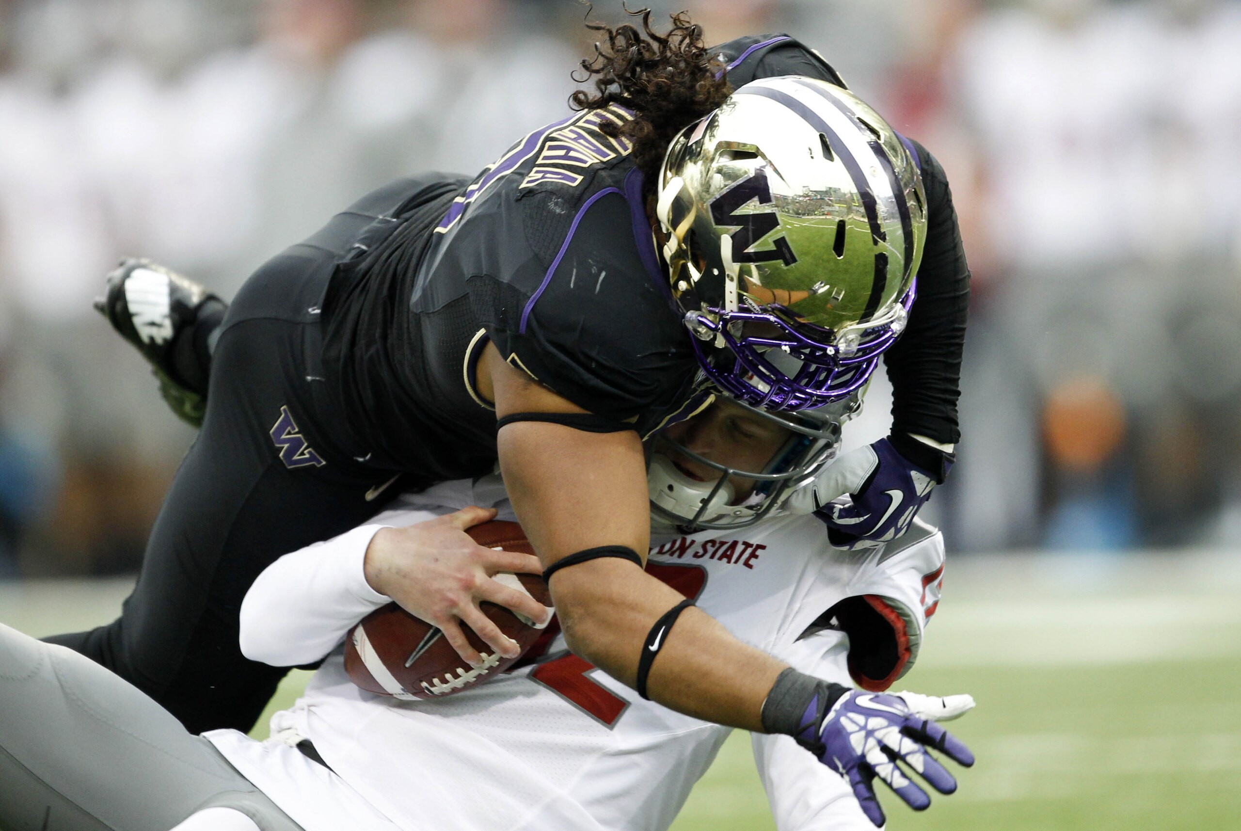 Nov 29, 2013; Seattle, WA, USA; Washington Huskies defensive end Hau'oli Kikaha (8) sacks Washington State Cougars quarterback Connor Hlliday (12) during the second quarter at Husky Stadium. Mandatory Credit: Joe Nicholson-USA TODAY Sports
